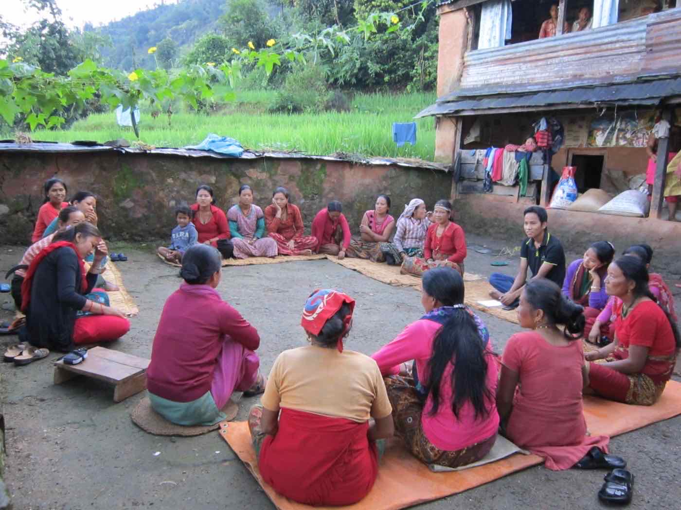 Women gathered outdoors to form a Women Action Group in Lamatol