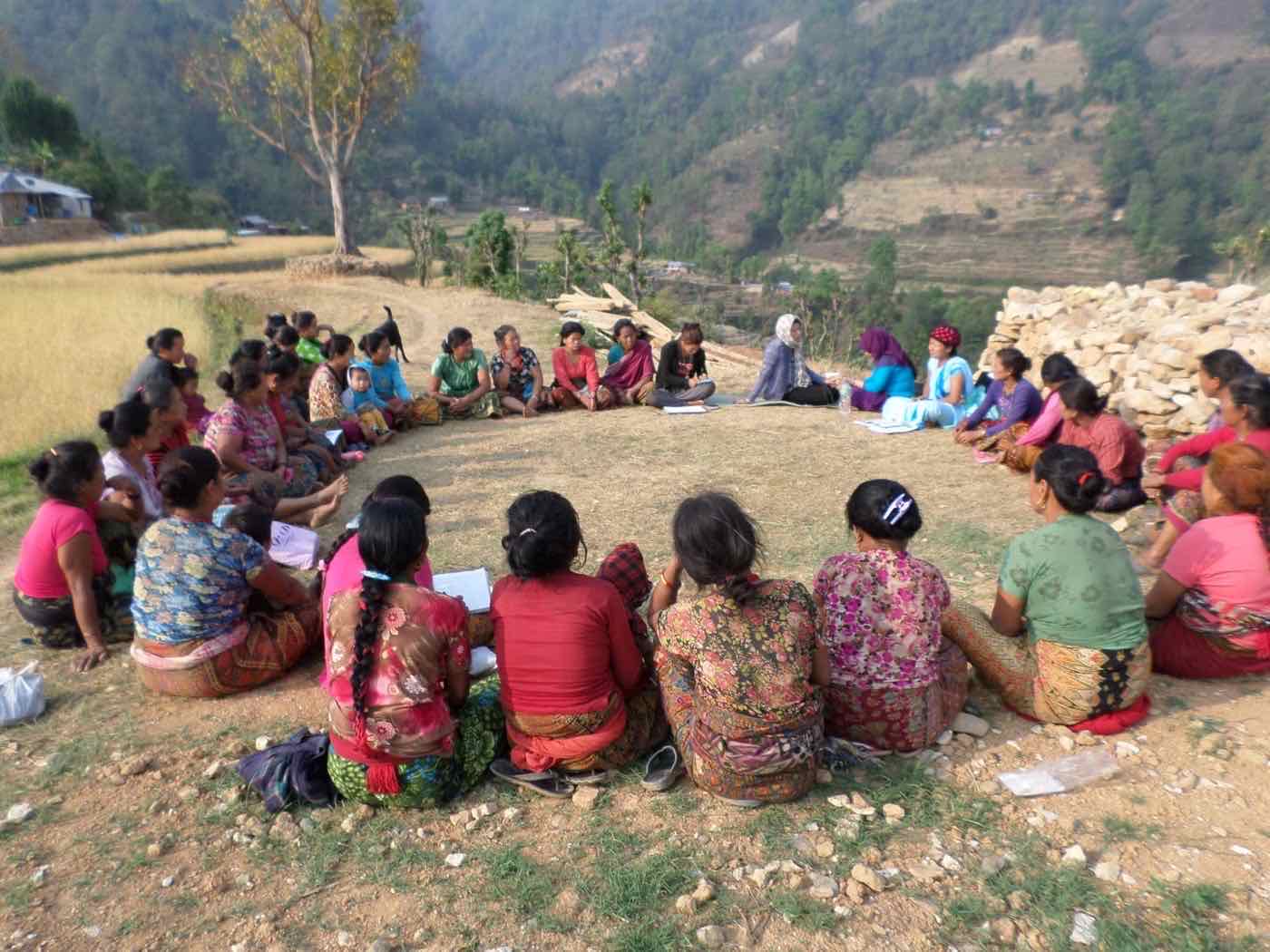 Women gathered outdoors for an Action Based Community Development meeting in Nuwakot