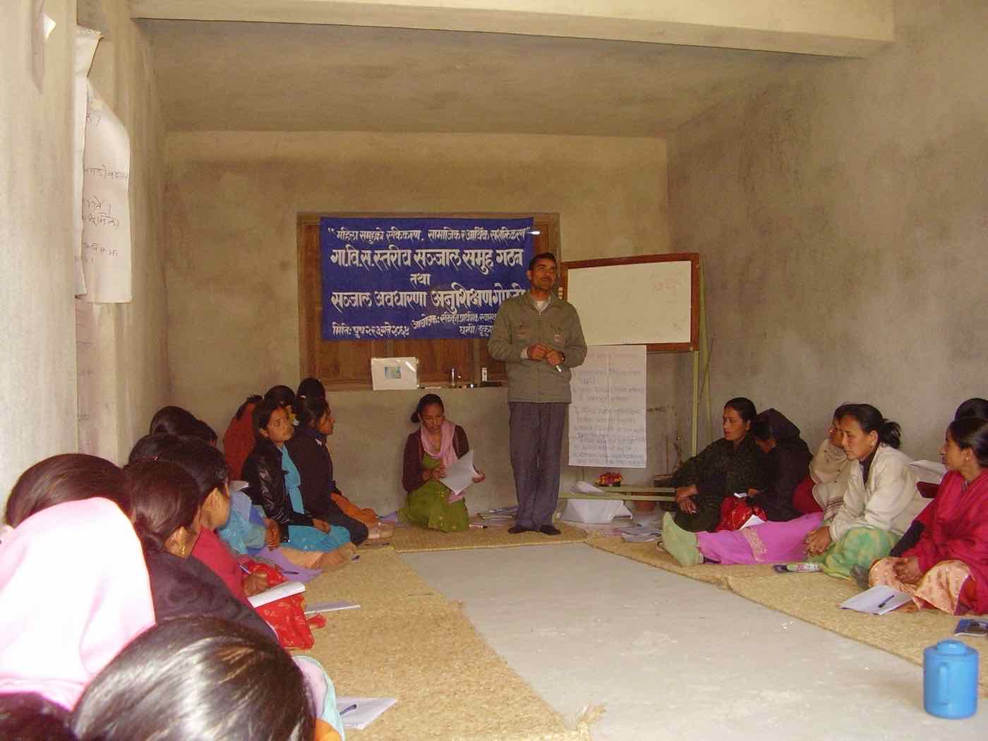 Participants seated around a facilitator at an AWEP network formation and orientation workshop