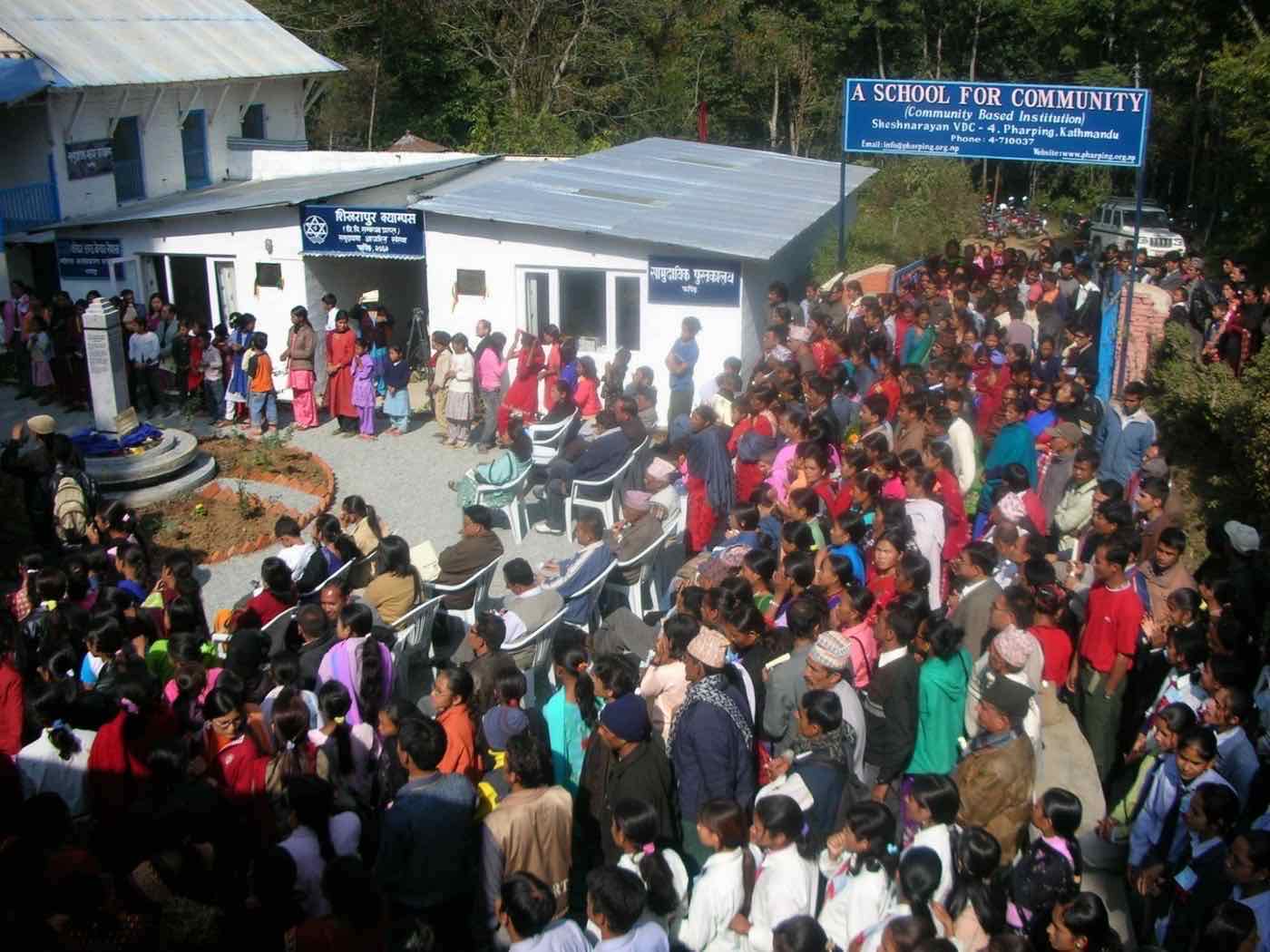 A large community gathering outside A School for Community in Pharping