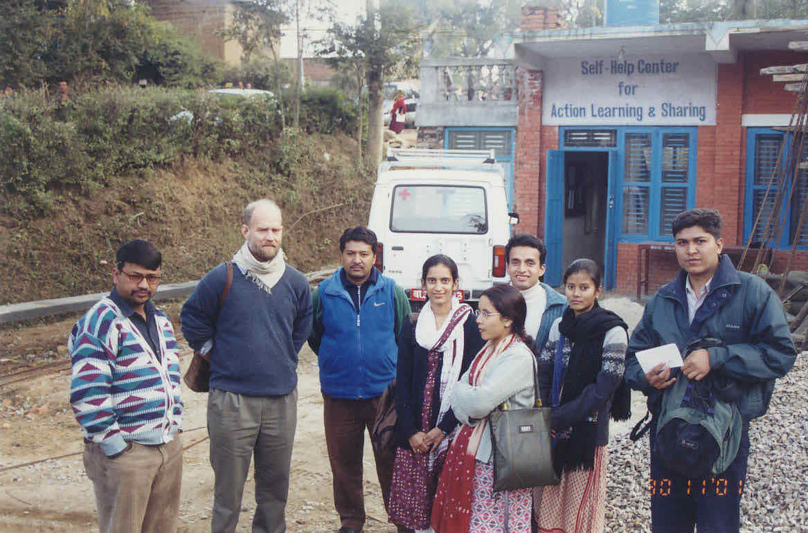 Project staff and visitors outside the Self-Help Center for Action Learning & Sharing