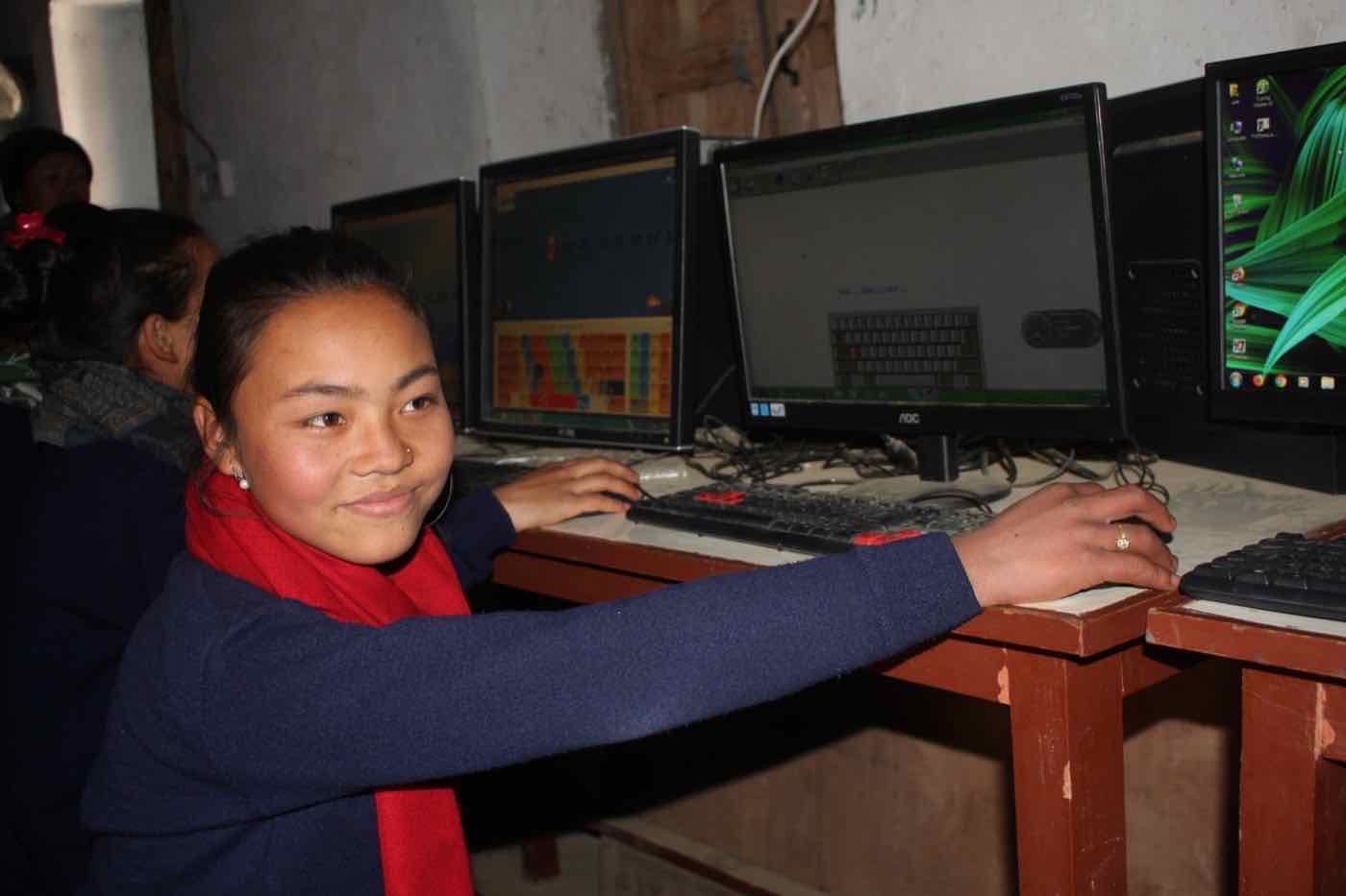 A Child Awareness Group member learning computer skills through the Dignity Project