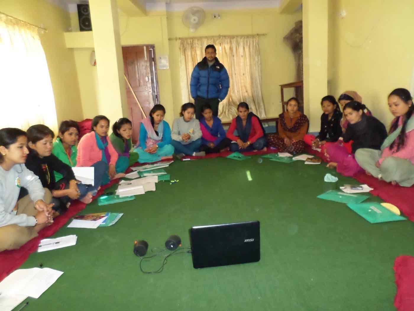 Adolescent girls seated in a circle during an e-WDC education session