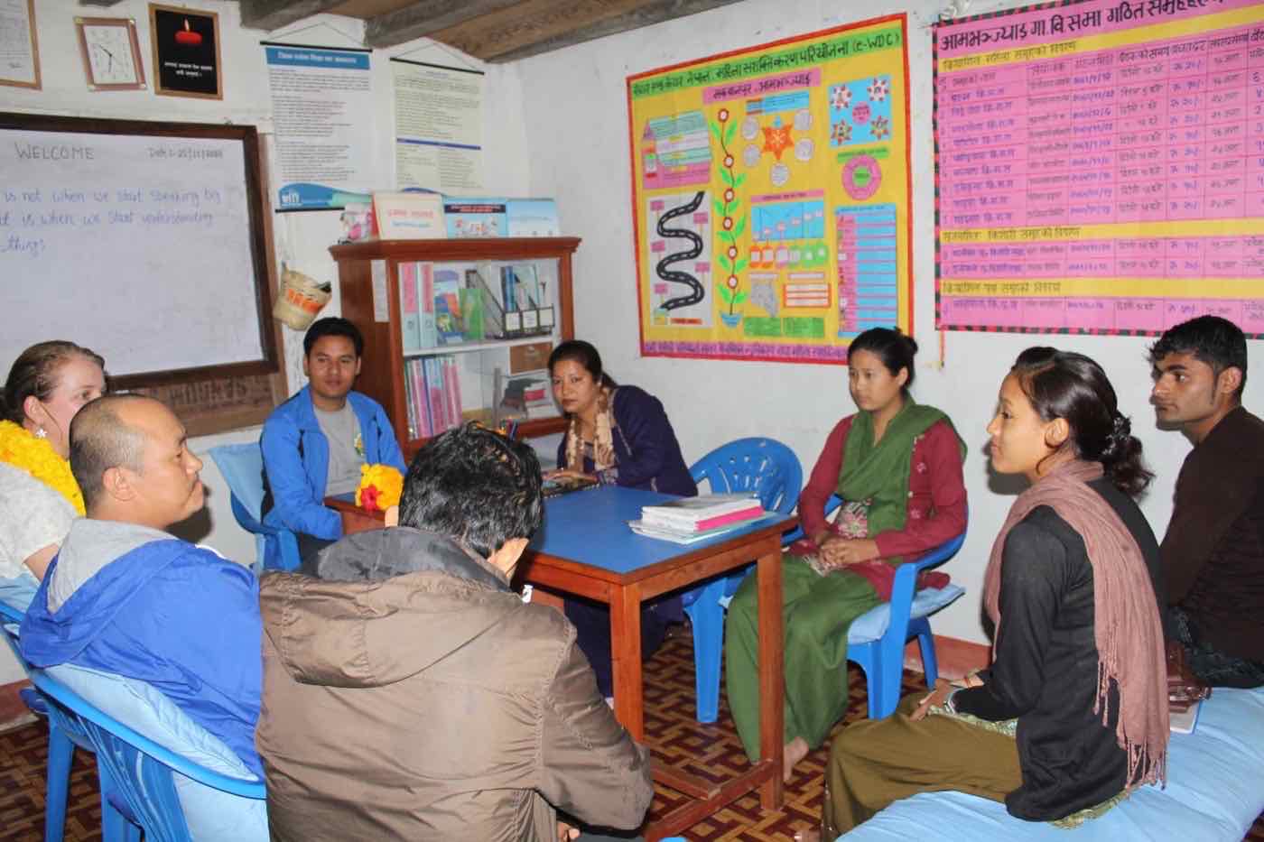 An e-WDC women's group meeting in Ambhanjyang, Makwanpur, beneath project record charts