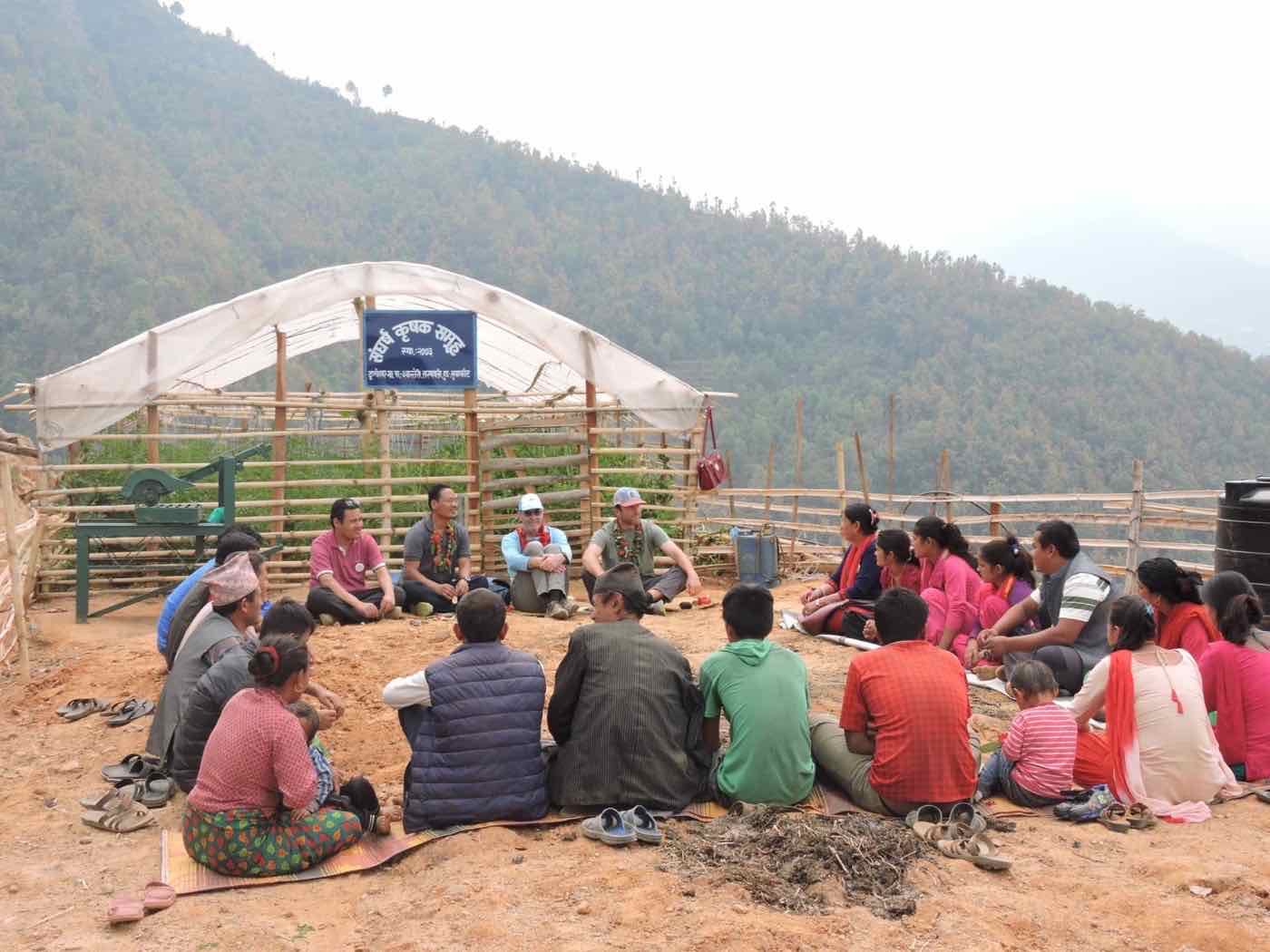 A community meeting in front of a commercial greenhouse in Samundratar during the Harmony Project