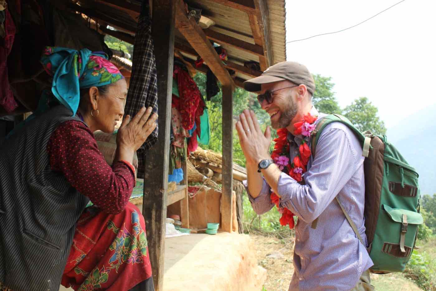 A woman of the Dhandakharka women's group greeting a visitor with namaste in Samundratar