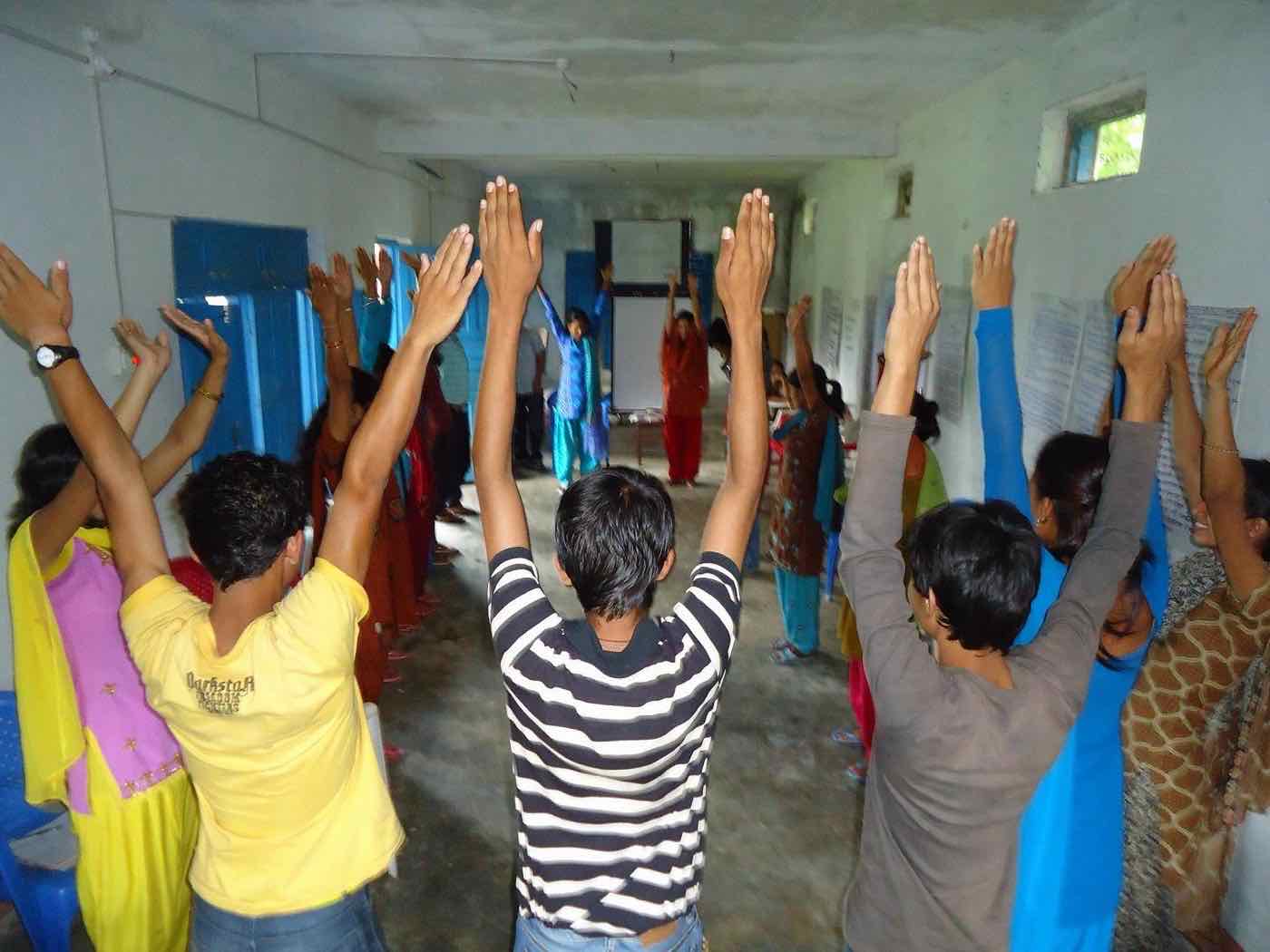 Human Liberty Project volunteers raising their hands in solidarity against human trafficking