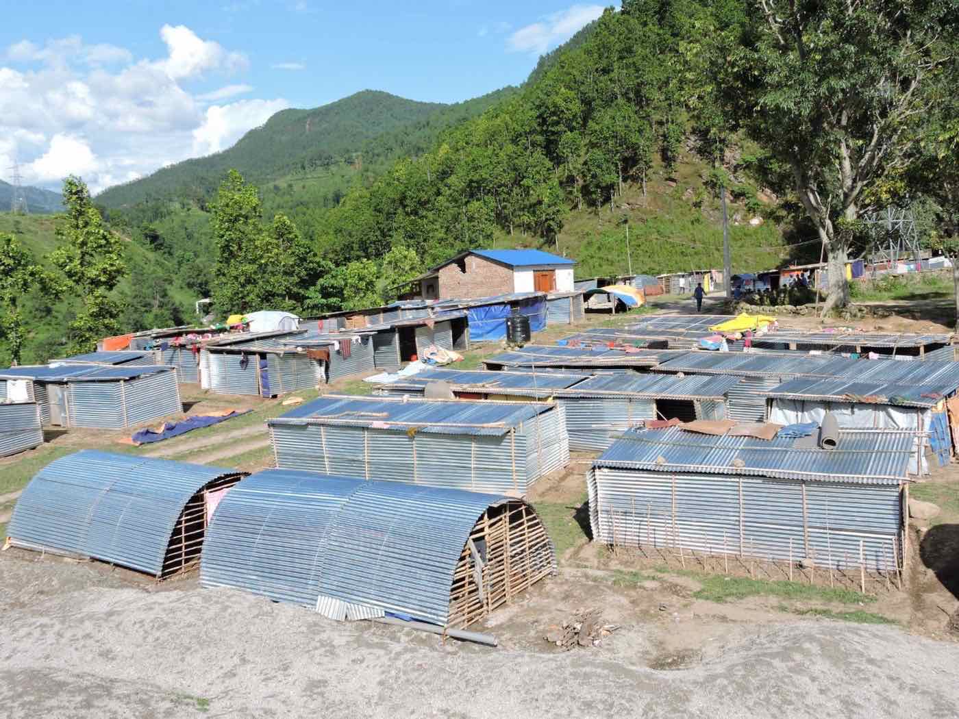 Rows of corrugated transitional shelters built on a hillside after the 2015 earthquakes