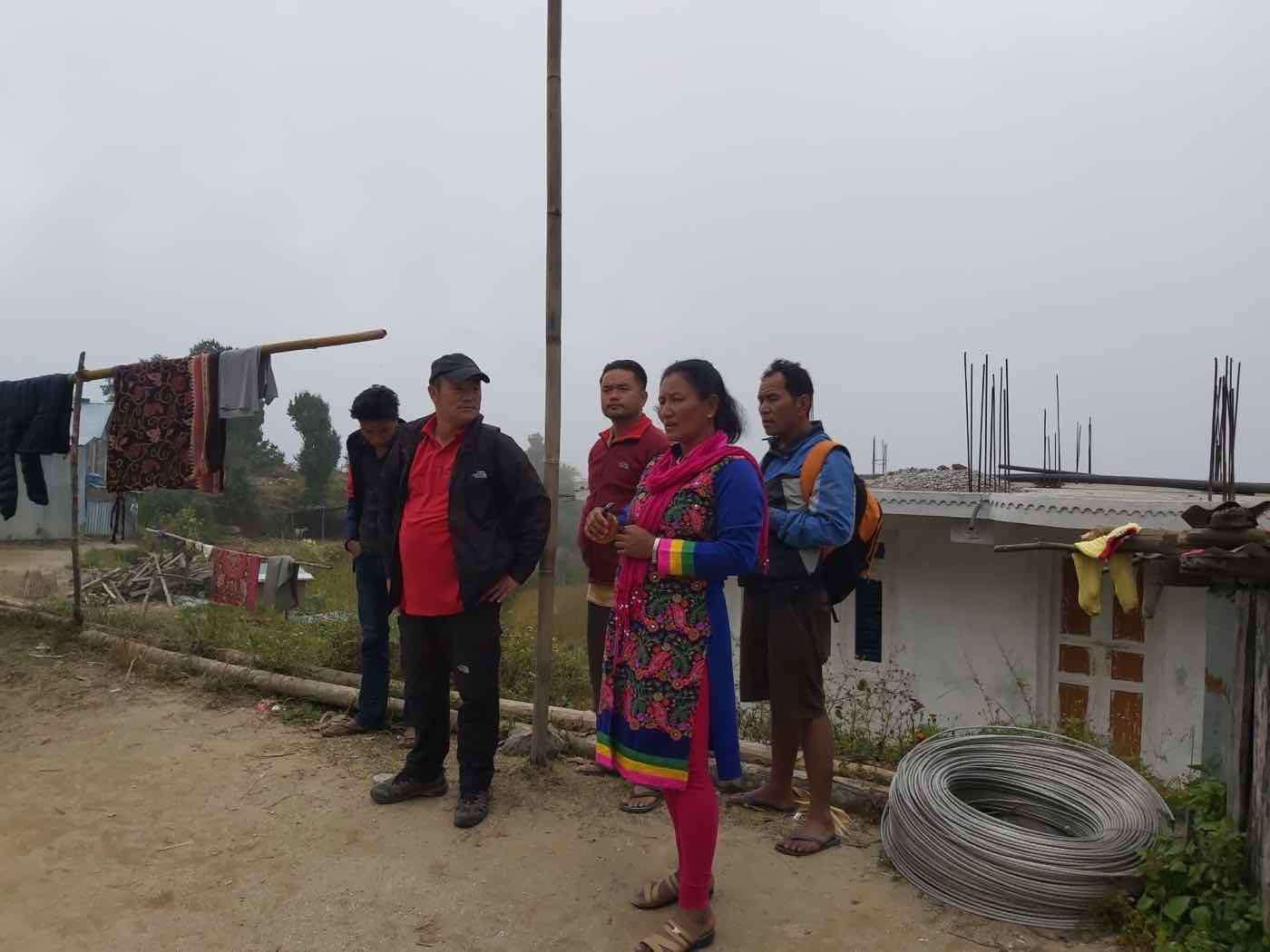 Joy Project staff talking with community members during a field visit in Betini, Nuwakot