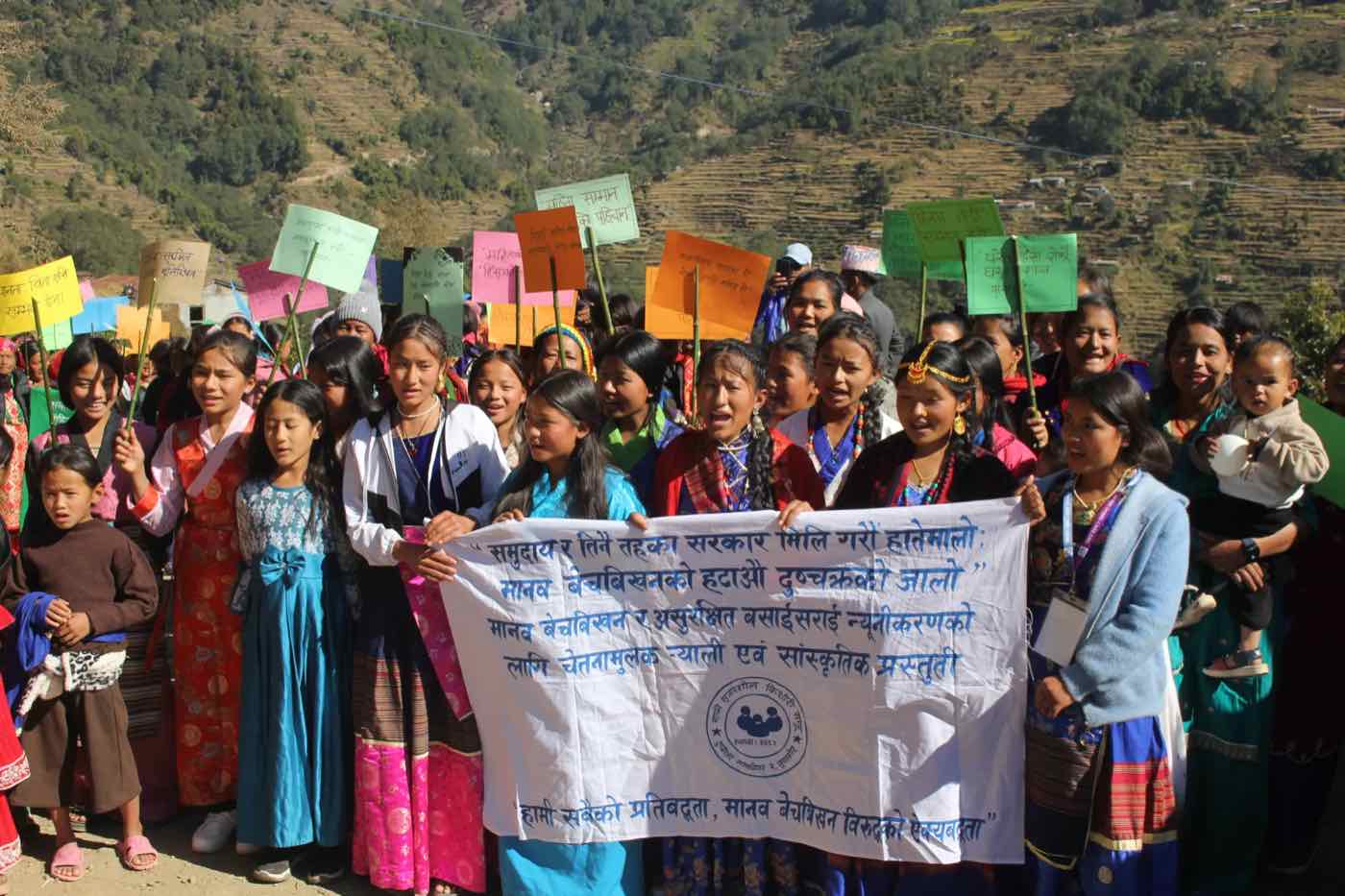 Women and girls marching with placards and a banner against human trafficking and unsafe migration, Dignity for Life Project in Gaunkharka, Dupcheshwor, Nuwakot