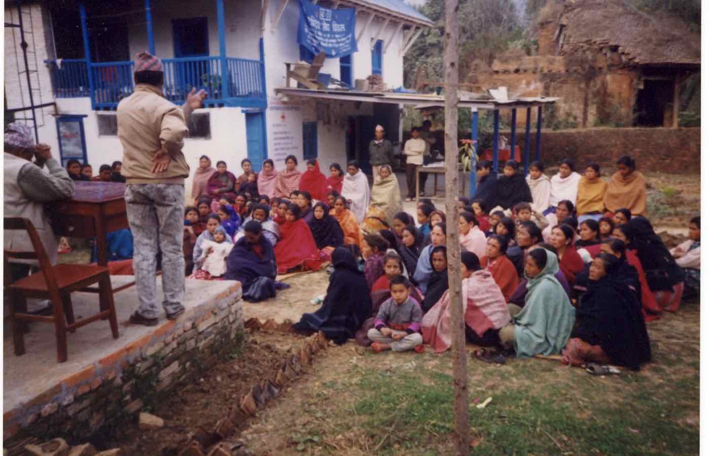 Ramesh addressing a large gathering of women outside the Pharping clinic