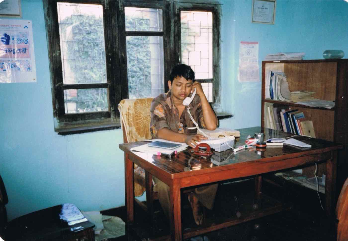 An early CBHDP staff member at his desk in the clinic office
